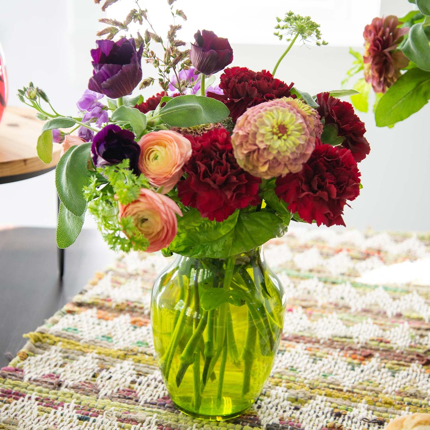 Colorful flowers in a green rose vase