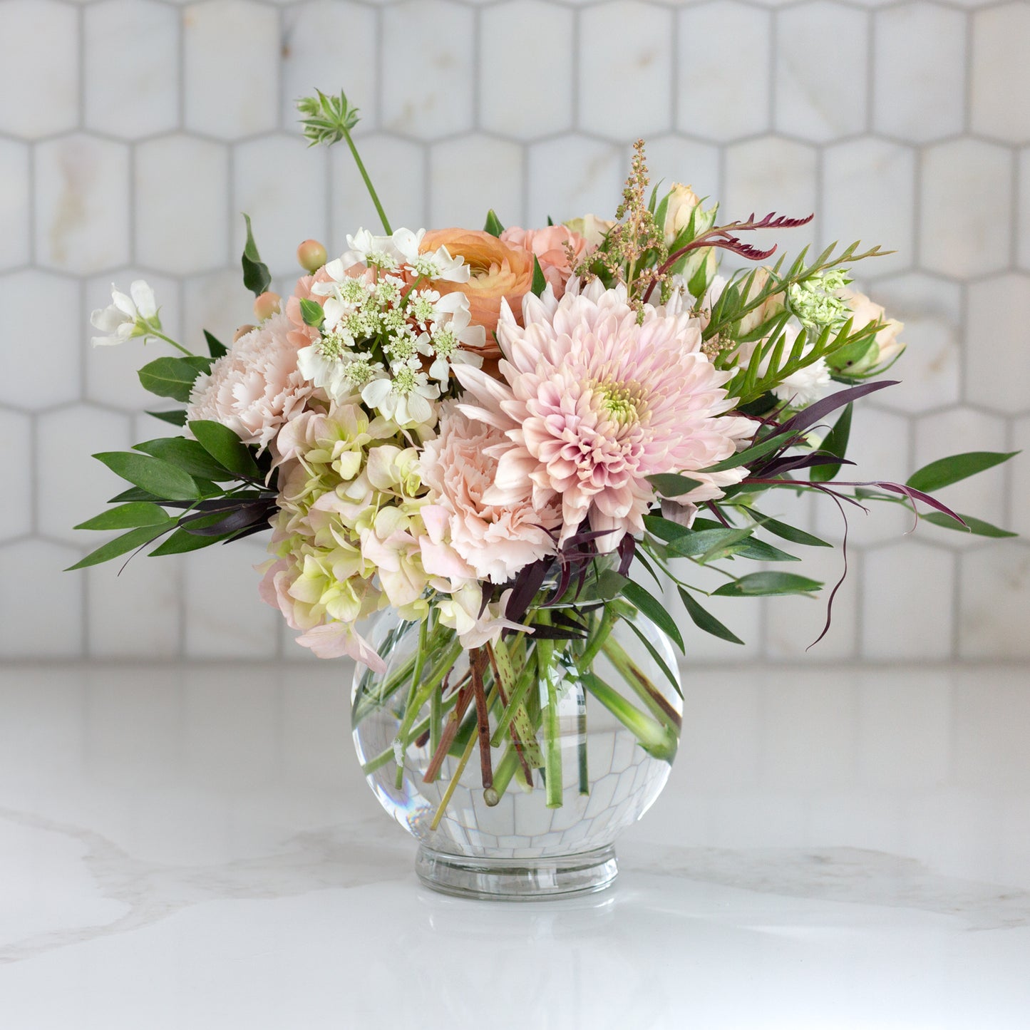 flower arrangement in an affordable glass ivy bowl