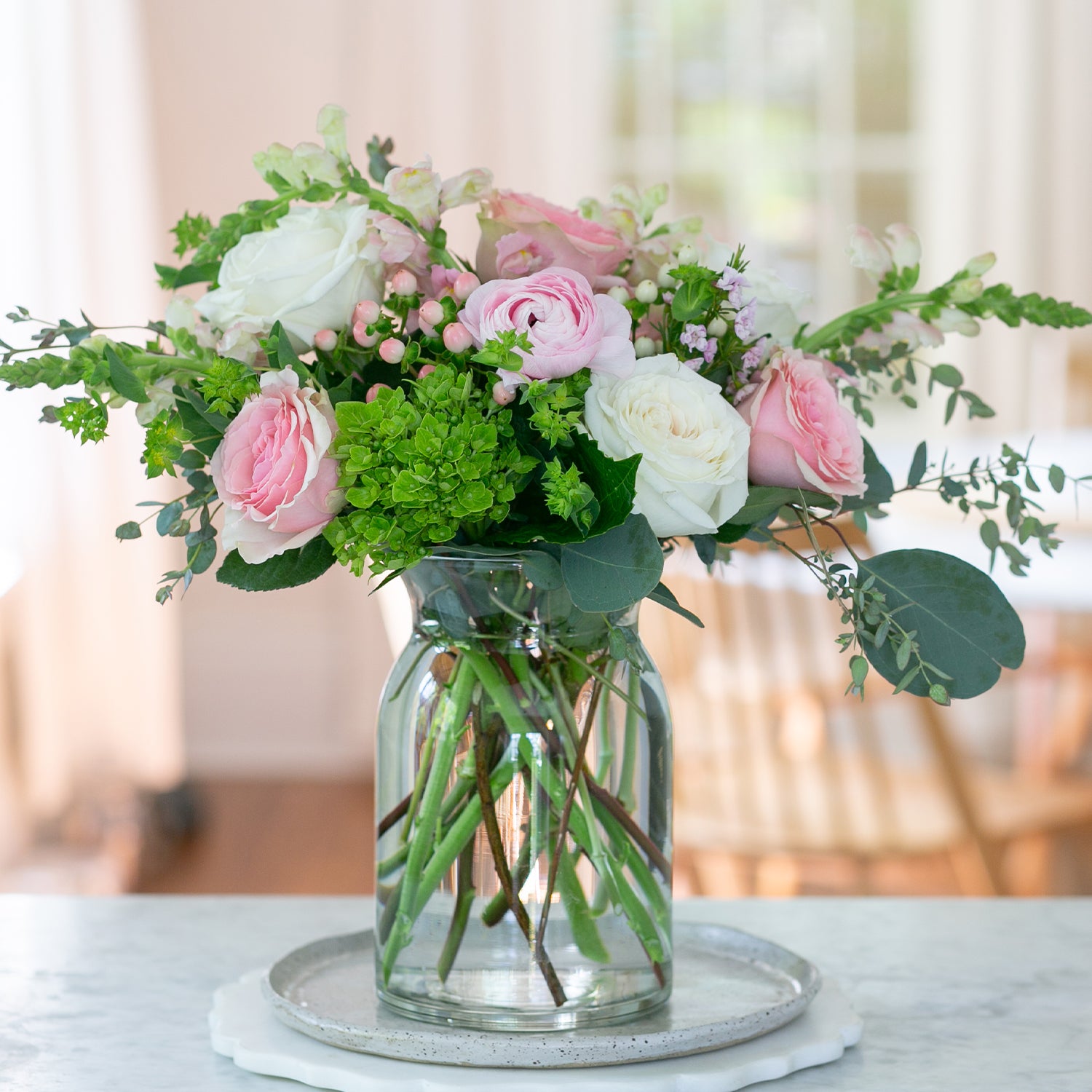 beautiful clear glass  8" milk jug style vase with pink and white roses