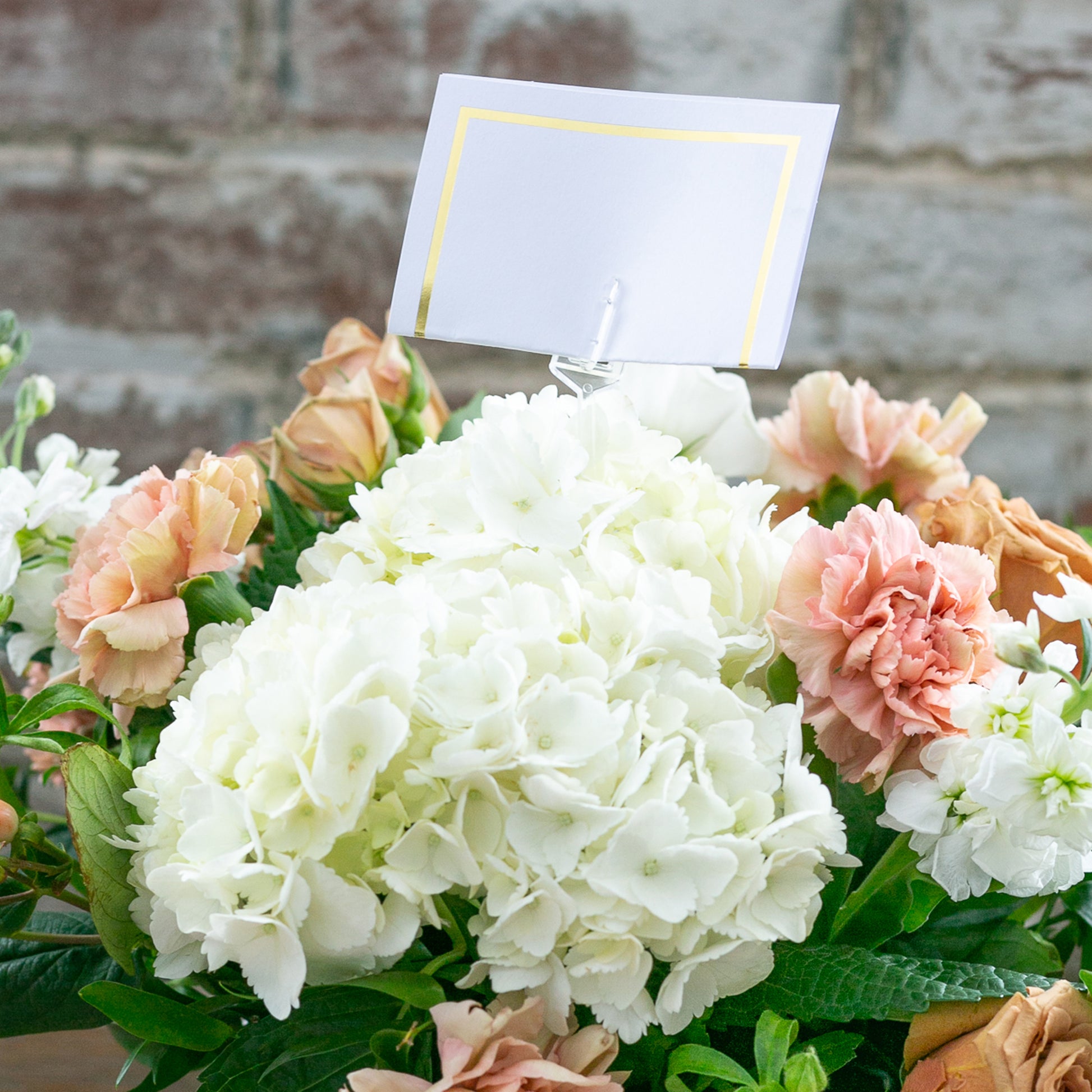 Flower arrangement with an 18" cardette pick holding a message in it.