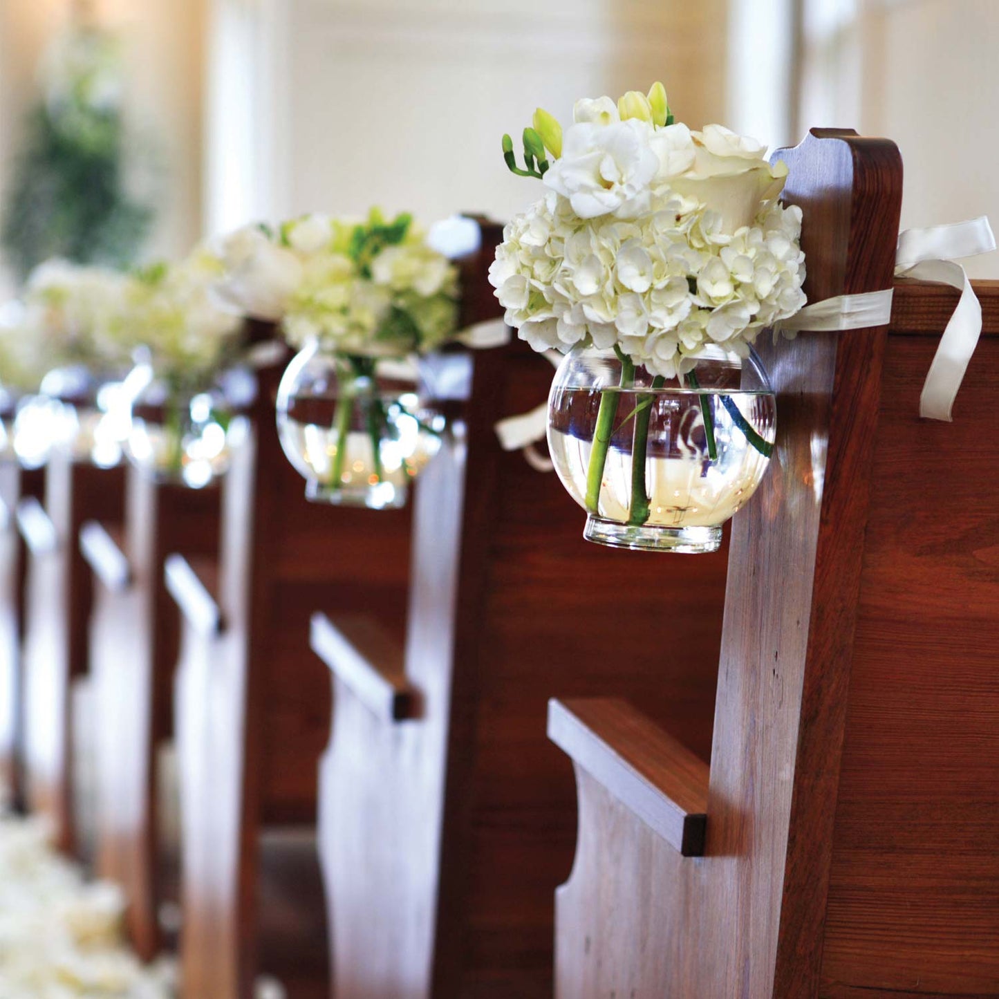 glass bowl holding flowers at a wedding 