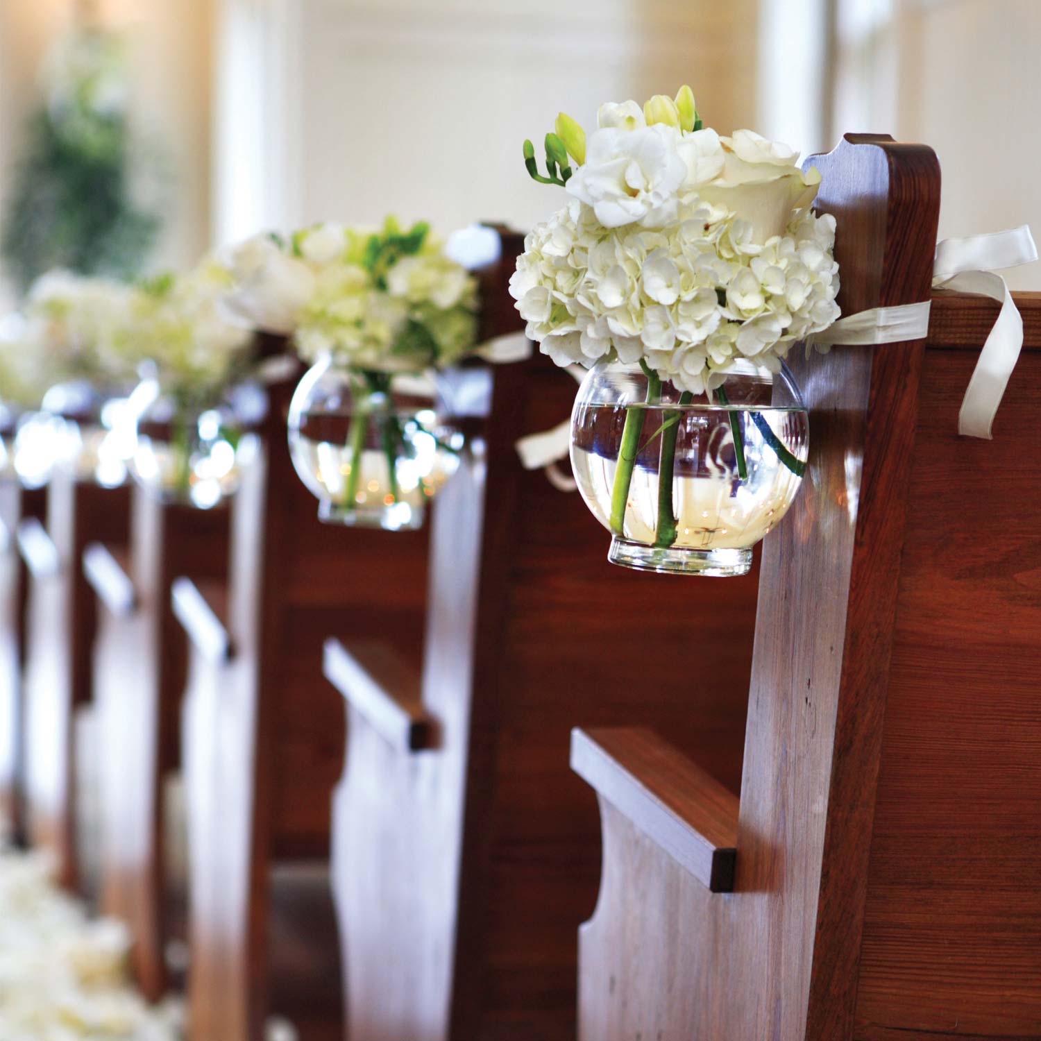 glass bowl holding flowers at a wedding 