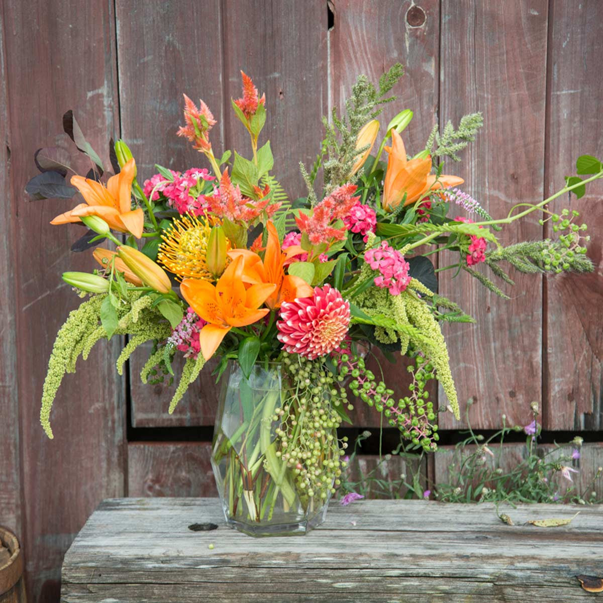 large prism vase filled with orange and pink flowers